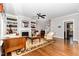Cozy living room featuring built-in bookshelves, a fireplace, hardwood floors, and large windows at 105 Everam Ct, Chapel Hill, NC 27516