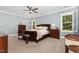 Comfortable main bedroom with a ceiling fan, two windows with white shutters, and two dark wooden bedside tables at 105 Everam Ct, Chapel Hill, NC 27516