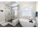 Luxurious bathroom featuring a modern shower and freestanding tub, perfect for relaxation and spa days at 106 Garrison Farm Rd, Mebane, NC 27302