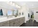 Spacious bathroom with double vanity sinks, modern fixtures, and a connecting door to a walk-in closet at 106 Garrison Farm Rd, Mebane, NC 27302