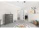 Bedroom showcases playful decor, gray dresser and alphabet rug leading to en-suite bathroom at 106 Garrison Farm Rd, Mebane, NC 27302
