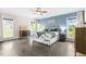 Comfortable bedroom with accent wall, large windows, and classic furnishings for a peaceful retreat at 106 Garrison Farm Rd, Mebane, NC 27302