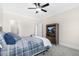 Comfortable bedroom with blue plaid bedding, a ceiling fan, and a modern entertainment center at 106 Garrison Farm Rd, Mebane, NC 27302