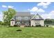 Stunning two-story home featuring a brick facade and beautiful manicured lawn and professional landscaping at 106 Garrison Farm Rd, Mebane, NC 27302