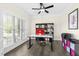 Bright office space with large window, modern desk, and built-in shelving for storage and organization at 106 Garrison Farm Rd, Mebane, NC 27302