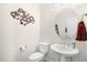 Charming powder room featuring a pedestal sink, decorative mirror, and elegant wall art at 106 Garrison Farm Rd, Mebane, NC 27302