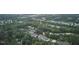 An aerial photograph of a densely wooded residential area near a golf course at 106 Rock Nest Ct, Morrisville, NC 27560