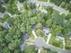 An aerial view showcases a lush, green neighborhood nestled among mature trees and winding streets at 106 Rock Nest Ct, Morrisville, NC 27560
