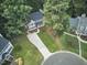 Aerial view of home with a welcoming front porch, neat landscaping, and a long driveway at 106 Rock Nest Ct, Morrisville, NC 27560