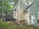 Exterior of home showcasing a screened porch, a patio, and a well-maintained yard with lush greenery at 106 Rock Nest Ct, Morrisville, NC 27560