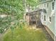 Overhead view of the backyard with a screened porch, landscaping, and a lush green lawn at 106 Rock Nest Ct, Morrisville, NC 27560