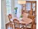 A dining room has hardwood floors, a wood table, four chairs, and china cabinet at 106 Rock Nest Ct, Morrisville, NC 27560