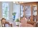 Dining room featuring a wooden table, china cabinet, and bright windows at 106 Rock Nest Ct, Morrisville, NC 27560