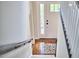 View from the staircase looking down towards the entryway with a light-filled front door and hardwood floors at 106 Rock Nest Ct, Morrisville, NC 27560
