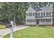 Two-story home with green lawn, enhanced by well-kept landscaping and leafy surrounding trees at 106 Rock Nest Ct, Morrisville, NC 27560