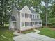 Aerial view of a beautifully landscaped home with a well-maintained lawn, mature trees, and a welcoming porch at 106 Rock Nest Ct, Morrisville, NC 27560