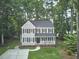Aerial view showcasing an attractive home with manicured lawns and mature trees at 106 Rock Nest Ct, Morrisville, NC 27560