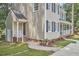Charming two-story home with tan siding, black shutters, front porch, and lovely landscaped yard at 106 Rock Nest Ct, Morrisville, NC 27560