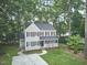 Charming two-story home features a welcoming front porch, neat landscaping, and a long driveway at 106 Rock Nest Ct, Morrisville, NC 27560