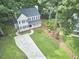 Charming two-story home features a welcoming front porch, neat landscaping, and a long driveway at 106 Rock Nest Ct, Morrisville, NC 27560