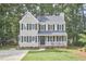 Charming two-story home with a manicured lawn, a welcoming front porch, and classic black shutters at 106 Rock Nest Ct, Morrisville, NC 27560