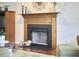 Living room fireplace featuring a stained wood mantel and hearth for a warm, inviting space at 106 Rock Nest Ct, Morrisville, NC 27560