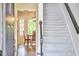 Foyer view toward dining area, staircase, and front door at 106 Rock Nest Ct, Morrisville, NC 27560