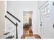 Bright foyer featuring a staircase, hardwood floors, and an entrance to the living area at 106 Rock Nest Ct, Morrisville, NC 27560