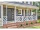 Charming front porch featuring a decorative railing, well-maintained brickwork, and manicured landscaping at 106 Rock Nest Ct, Morrisville, NC 27560