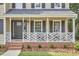 Cozy front porch featuring decorative railing, modern lighting, and well-manicured landscaping at 106 Rock Nest Ct, Morrisville, NC 27560