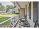 Comfortable front porch features cozy rocking chairs, decorative railings, and a glimpse of the neighborhood at 106 Rock Nest Ct, Morrisville, NC 27560