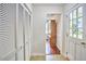 Hallway features a tiled floor, closet space, and an open view to the living area with hardwood floors at 106 Rock Nest Ct, Morrisville, NC 27560