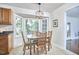 Bright breakfast nook featuring a bay window view and a chandelier, complementing the dining set at 106 Rock Nest Ct, Morrisville, NC 27560