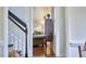 View from the hallway into the living room; beautiful hardwood floors and green sofas at 106 Rock Nest Ct, Morrisville, NC 27560