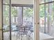 Bright and inviting screened-in porch, furnished with a dining table and chairs for relaxation at 106 Rock Nest Ct, Morrisville, NC 27560