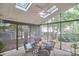 Cozy screened-in porch with skylights, fan, and a dining set, offering a relaxing outdoor living space at 106 Rock Nest Ct, Morrisville, NC 27560