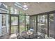 Bright screened-in porch with skylights and a comfortable dining area, perfect for enjoying the outdoors at 106 Rock Nest Ct, Morrisville, NC 27560