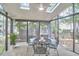 Charming screened-in porch with ample seating, creating an inviting space for outdoor relaxation and dining at 106 Rock Nest Ct, Morrisville, NC 27560