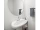 Bathroom featuring a modern sink, rounded mirror and stylish towel racks at 109 Periwinkle Pl, Clayton, NC 27527