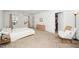 Calm bedroom featuring neutral tones, two windows, closet and a stylish rocker at 109 Periwinkle Pl, Clayton, NC 27527