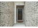 Charming brown front door with wreath and brick facade at 109 Periwinkle Pl, Clayton, NC 27527