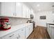Bright kitchen features white cabinetry, stainless appliances, herringbone backsplash and Quartz countertops at 109 Periwinkle Pl, Clayton, NC 27527