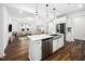 Spacious kitchen with white cabinets, stainless steel appliances, and a large island with seating at 109 Periwinkle Pl, Clayton, NC 27527