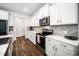 Kitchen featuring white cabinets, stainless steel appliances, granite countertops, and wood floors at 109 Periwinkle Pl, Clayton, NC 27527