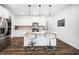 Bright kitchen with white cabinetry, stainless steel appliances, a large island, and modern bar stools at 109 Periwinkle Pl, Clayton, NC 27527