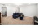 Bonus living room featuring an oversized couch and access to laundry room at 109 Periwinkle Pl, Clayton, NC 27527