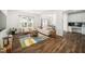 Bright living room with hardwood floors, modern furniture, a patterned rug, and natural light at 109 Periwinkle Pl, Clayton, NC 27527