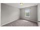 This bedroom features neutral walls, carpet, and a window letting in natural light at 1108 Renewal Pl, Raleigh, NC 27603