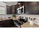 A kitchen showcasing granite countertops, stainless steel appliances, and dark wood cabinets that combine functionality and style at 1108 Renewal Pl, Raleigh, NC 27603