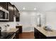 Close-up of the kitchen featuring stainless steel appliances, granite countertops, and dark wood cabinets at 1108 Renewal Pl, Raleigh, NC 27603